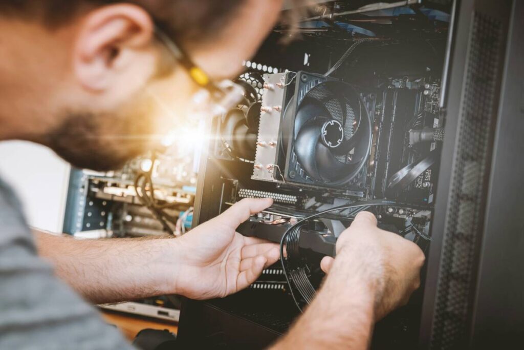 Technician installing computer hardware during a PC repair